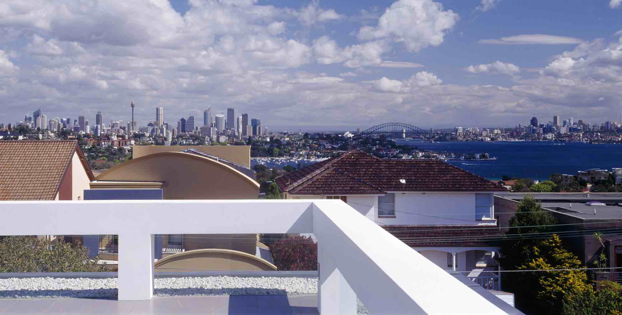 minosa-design-high-voids-sitting-room-modern-custom-joinery-gas-fireplace-limestone-floor-sydney-skyline-view-01