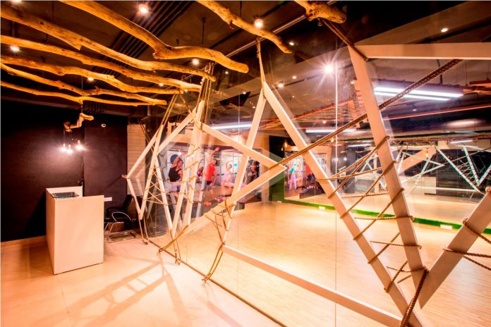 Moksha fitness and spa with overlapping and free standing triangular metal frames, crisscrossed with ropes, designed by Studio Ardete-05