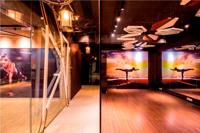 Moksha fitness and spa with overlapping and free standing triangular metal frames, crisscrossed with ropes, designed by Studio Ardete-11