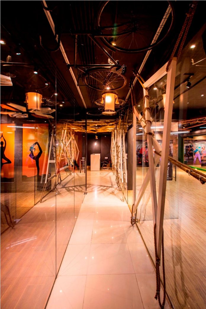 Moksha fitness and spa with overlapping and free standing triangular metal frames, crisscrossed with ropes, designed by Studio Ardete-12