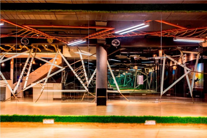 Moksha fitness and spa with overlapping and free standing triangular metal frames, crisscrossed with ropes, designed by Studio Ardete-19