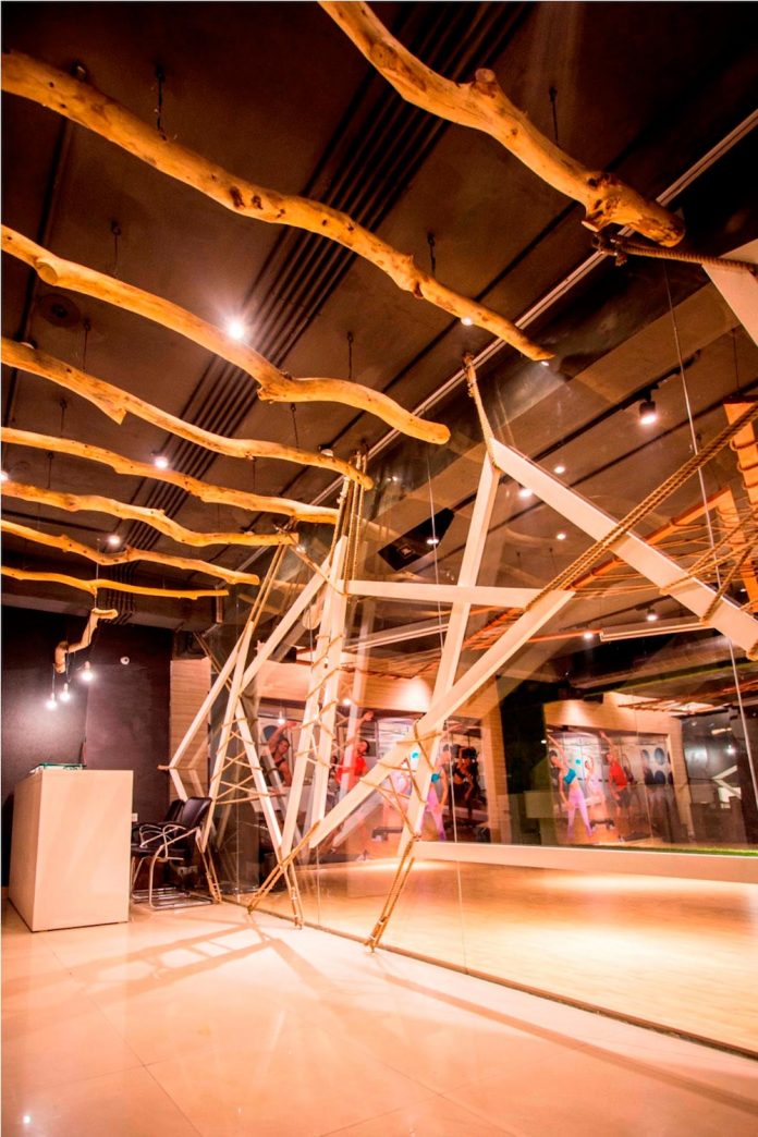 Moksha fitness and spa with overlapping and free standing triangular metal frames, crisscrossed with ropes, designed by Studio Ardete-22