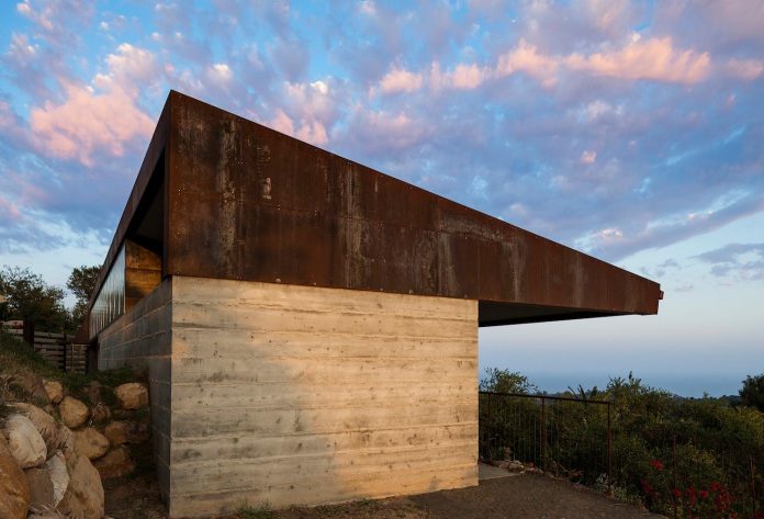 raw-corten-steel-concrete-exterior-dress-crossing-wall-house-sited-santa-ynez-mountains-meet-pacific-ocean-05