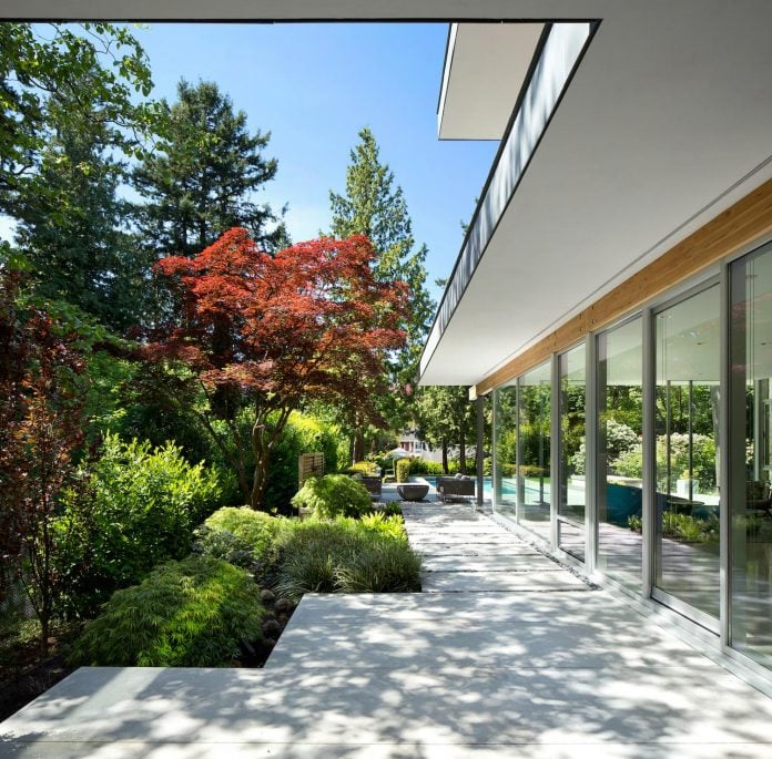 modern-elm-street-residence-is-dominated-by-very-mature-evergreen-trees-and-high-garden-hedges-04