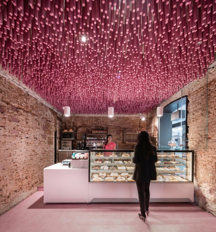 Bakery in Madrid with stunning 12,000 Pink-Painted Wooden Sticks Ceiling by Ideo arquitectura