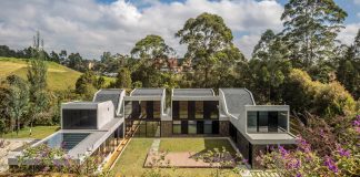 Plan B Arquitectos design VG House, a system of parallel concrete walls which define four volumes connected transversally