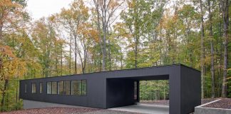 in situ studio design a low black box Corbett Residence settled on a wooded site