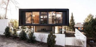 Modern house in Riehen made by glass, concrete, wood, and metal serve, designed by Reuter Raeber Architects