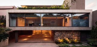 Caúcaso House rises above the sidewalk and over the surrounding trees