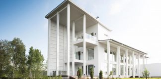Villa Muurame is a wooden 3-story, bright and white single-family home located near Lake Jyväsjärvi, Finland