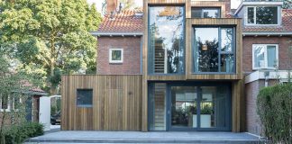 A timber clad extension creates a new relationship between a brick semi-detached house and its green surrounding