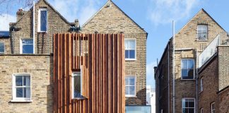 Typical London Victorian terraced house redesigned with highly sculptural timber clad rear extension