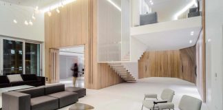 Penthouse defined by a cladded wooden skin and a floating structure suspended from the ceiling through vertical steel profiles