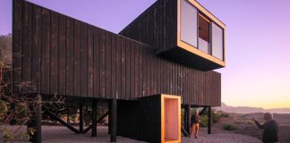 Two wooden waterfront houses compressed by the sea and a cliff in Puertecillo by 2DM