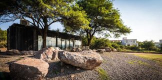 Residence in Argentina with two large trees above the structure that offer shade