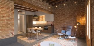 Contemporary flat in Barcelona’s Eixample defined by the Catalan hydraulic cement tiles and exposed brick walls and the wooden beamed ceilings