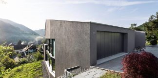 Single family house built on a steep slope that leads to the centre of a village