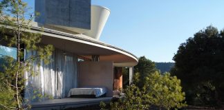 Solo House by Office KGDVS: a simple circular roof with large facade sliding glass walls located in a large untouched forest