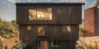 Three-story home bringing a sense of enclosure to the rear yard