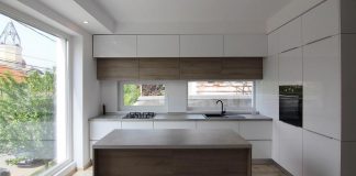 Project built on a very small piece of land with minimal modern features and design defined by white, black and timber hues