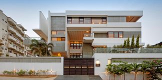 Building conceived as two programmed volumes held together by a bridge-corridor, landscaped courts, and shaded terraces