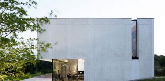 Building entirely constructed of white concrete which allows the inside of the house to profit from a maximum visual frame