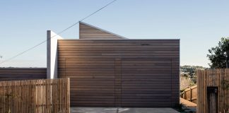 Home with understated facade that reveals little about the internal volumes one encounters upon entry